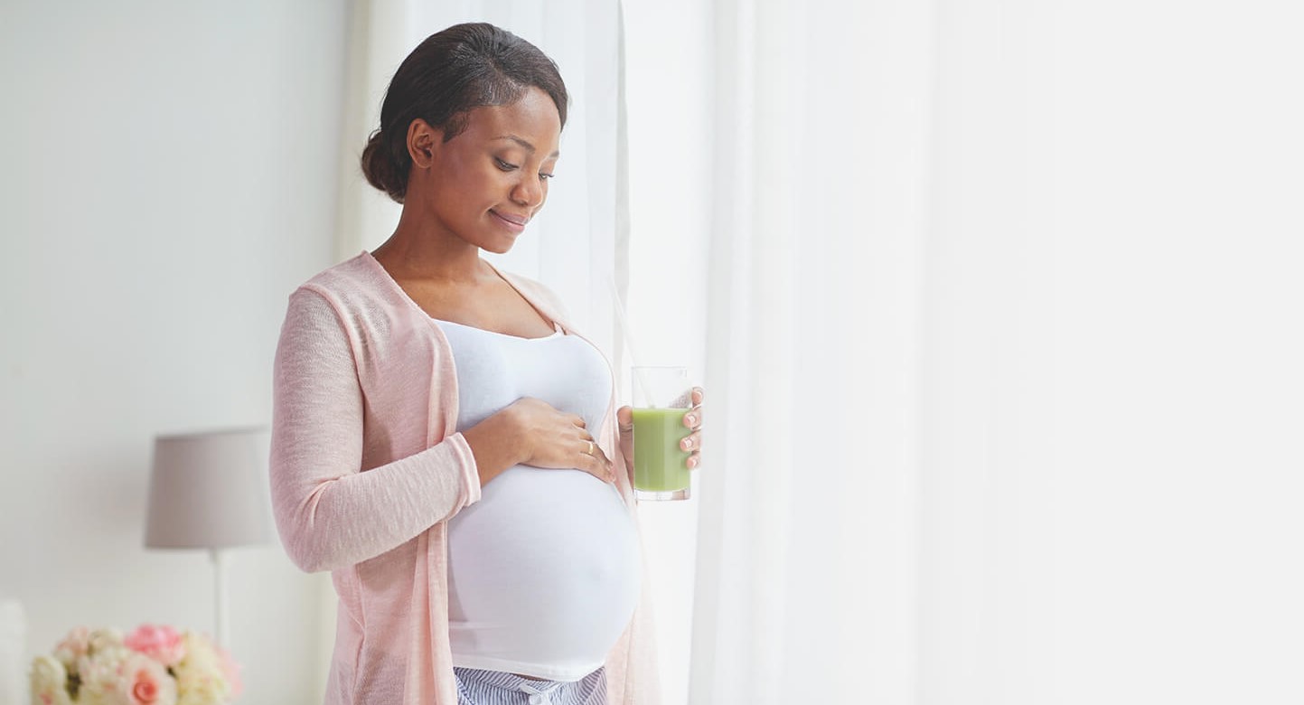 pregnant woman holding juice