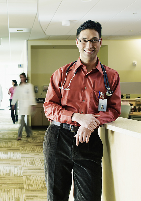 male doctor with glasses smiling